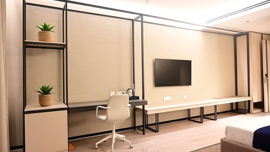 image featuring a work desk along with a wall mounted television in a room at club charholi, pune